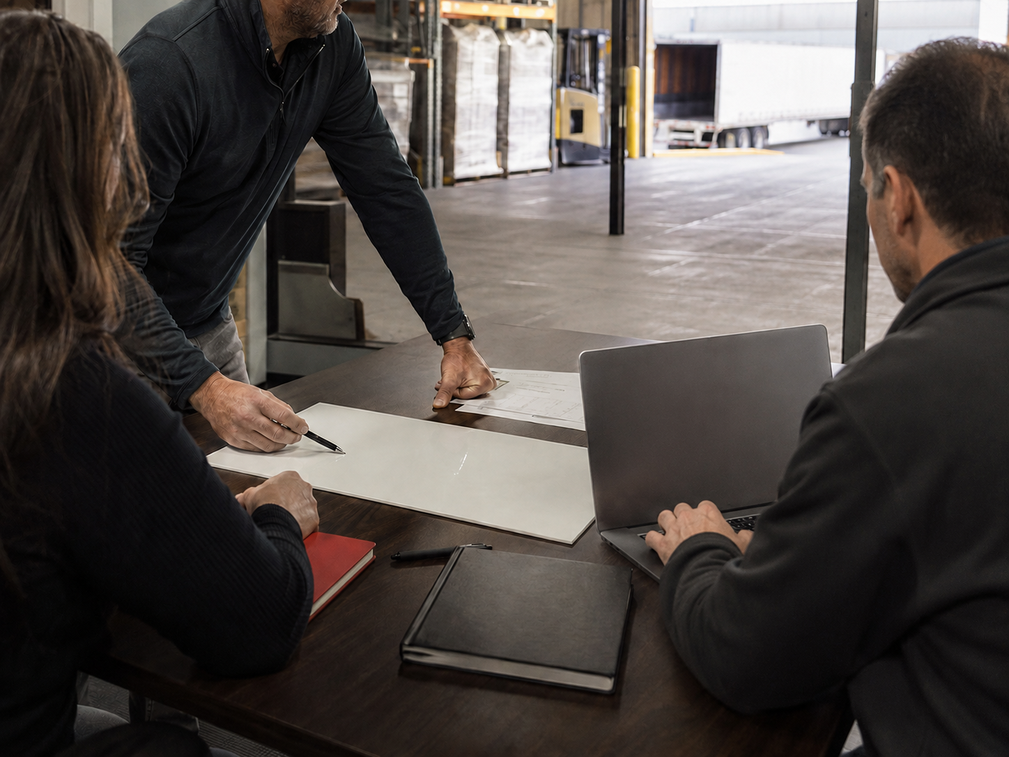 An experienced freight operator working through notes with a small logistics technology team